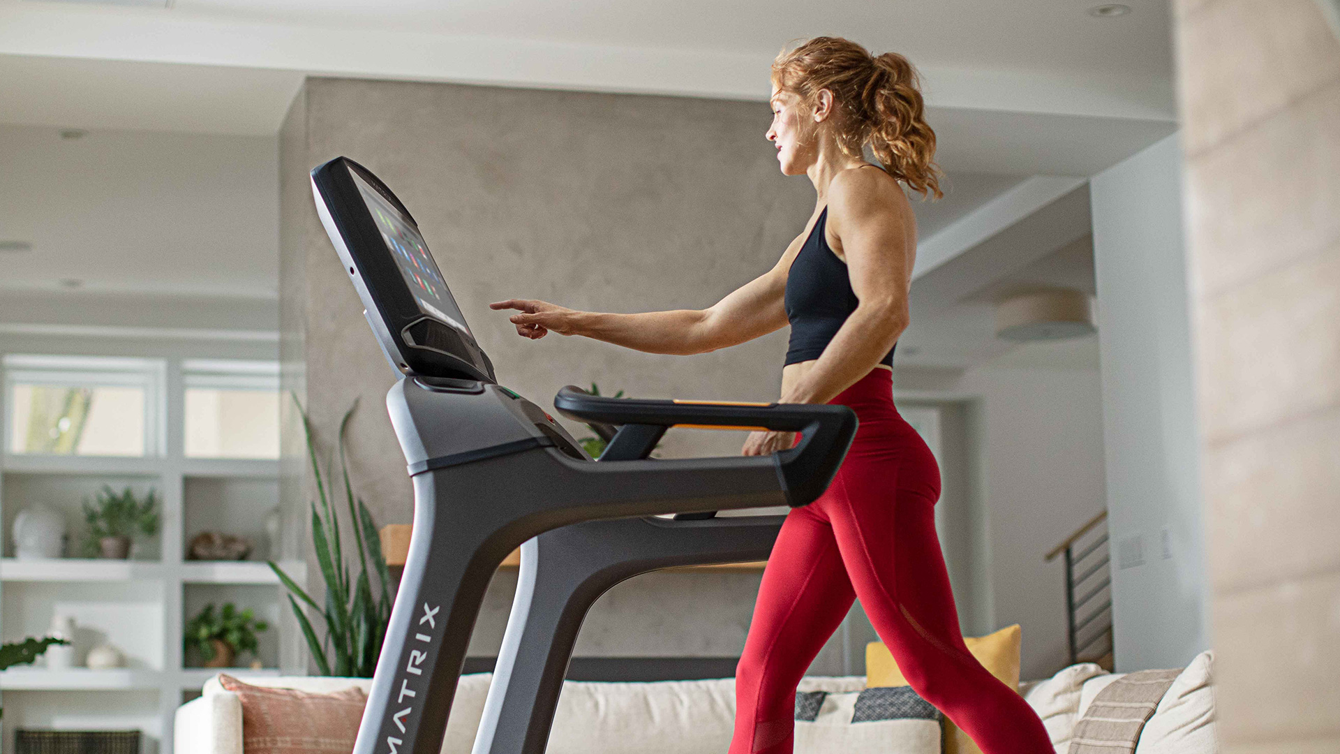 Woman walking on Matrix treamill in living room