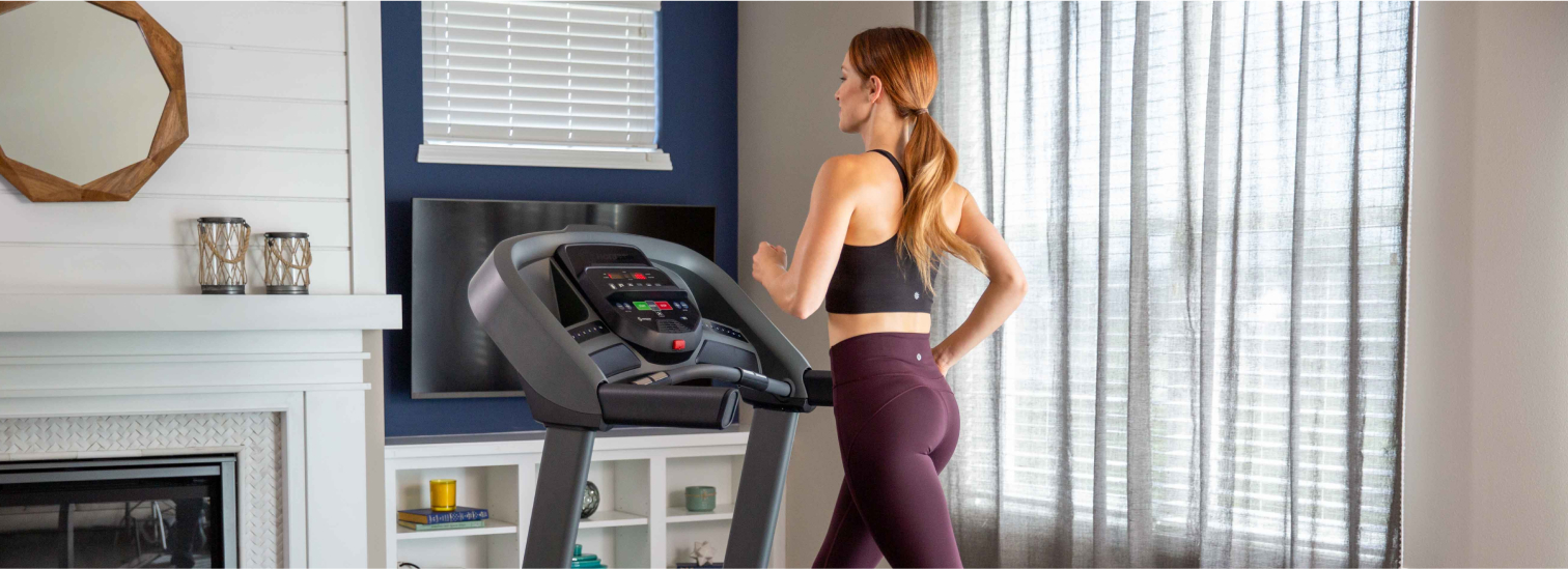 Woman running on Horizon T101 treadmill in her family room