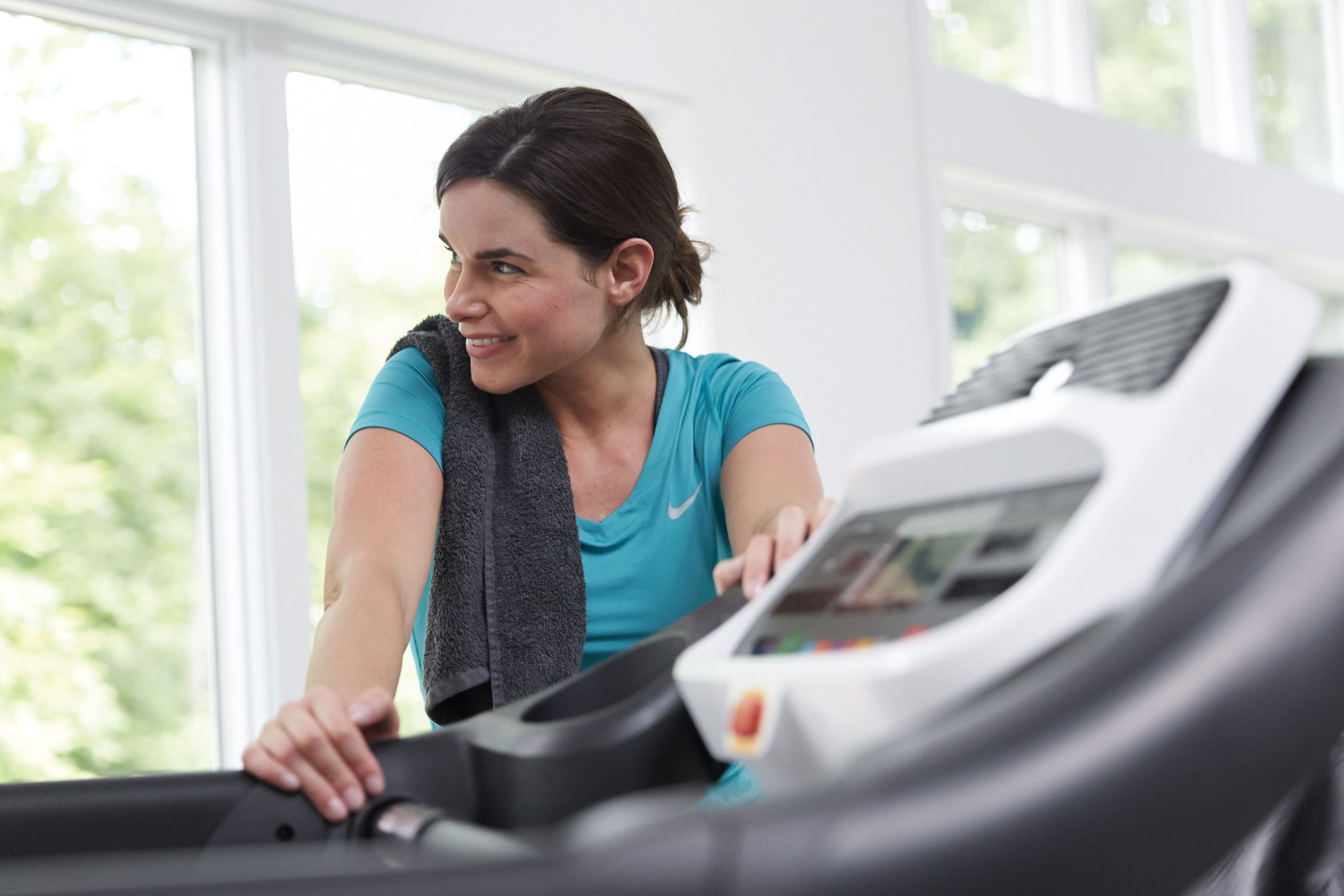 Woman holds onto a treadmill